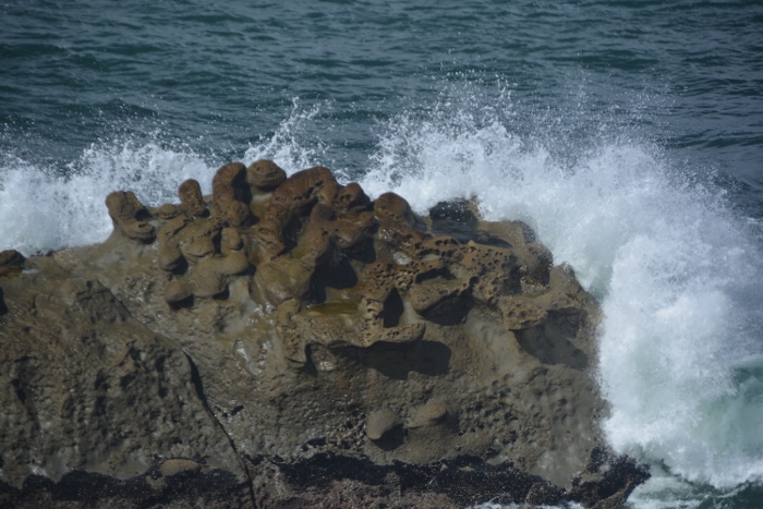 Waves hit the rocks offshore